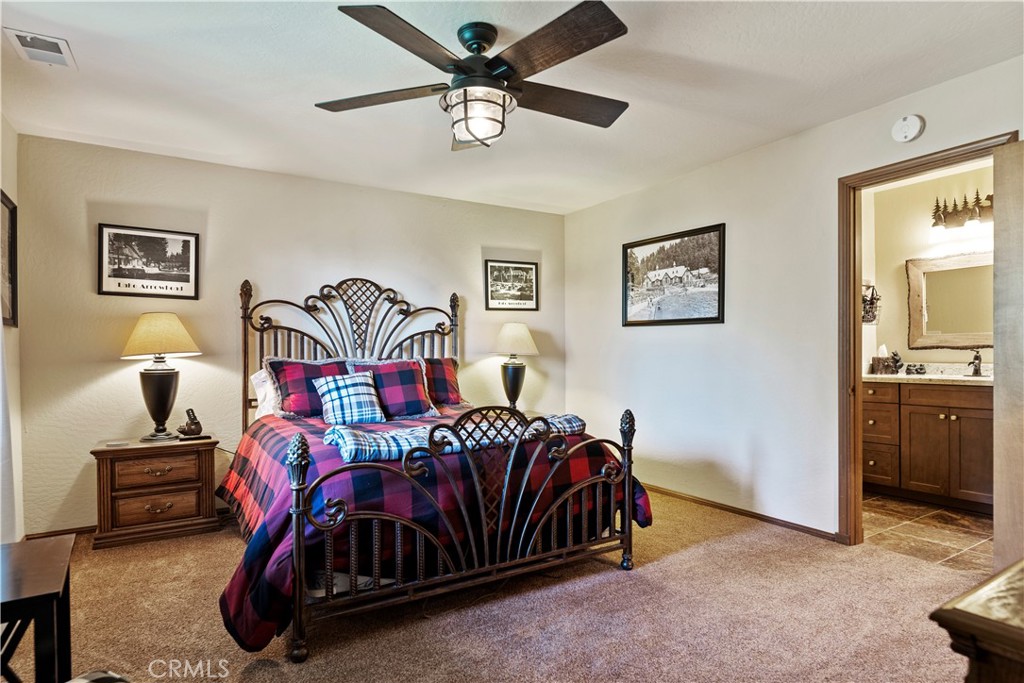 615 Wellesley Lake Arrowhead, CA 92352 - Photo 14 of 45 a bedroom with a bed and a chandelier