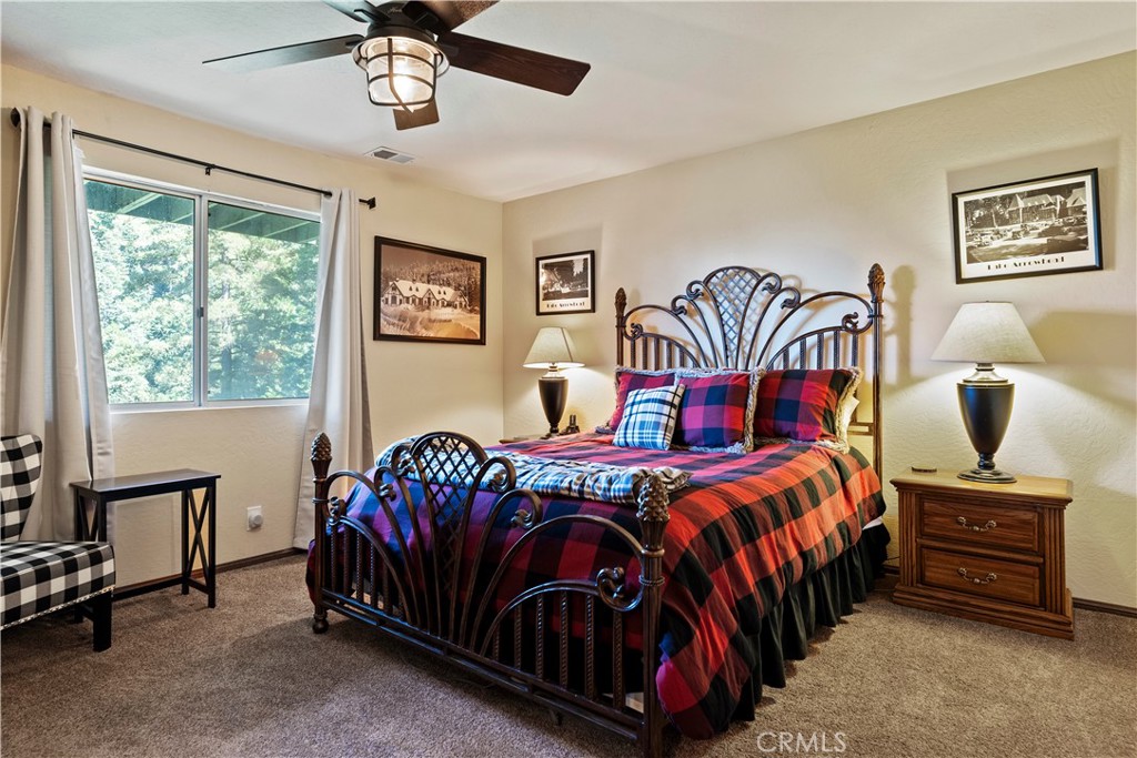 615 Wellesley Lake Arrowhead, CA 92352 - Photo 15 of 45 a bedroom with a bed and a chandelier