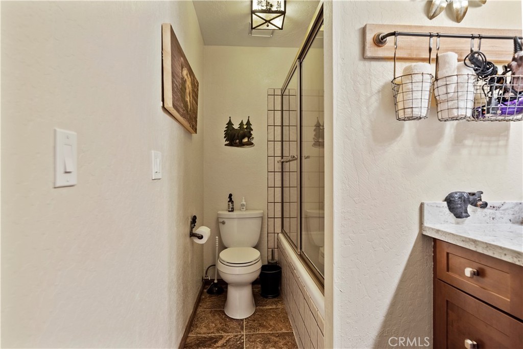 615 Wellesley Lake Arrowhead, CA 92352 - Photo 16 of 45 a bathroom with a granite countertop sink toilet and shower