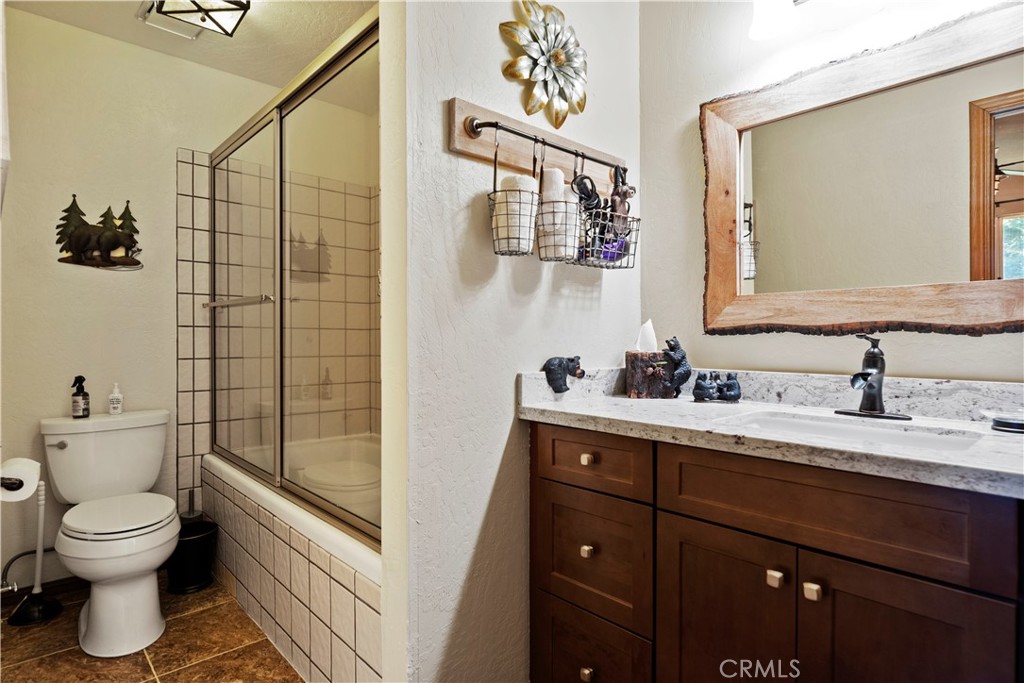 615 Wellesley Lake Arrowhead, CA 92352 - Photo 17 of 45 a bathroom with a toilet sink and mirror