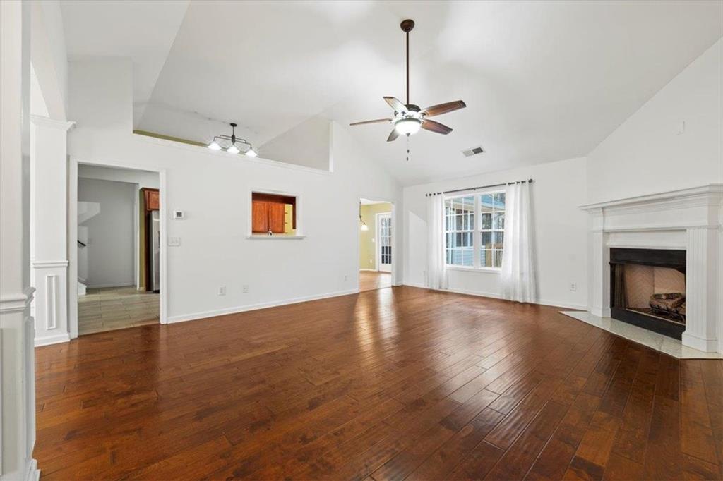 1218 Morgans Run Monroe, GA 30656 - Photo 28 of 39 a view of an empty room with a fireplace and wooden floor
