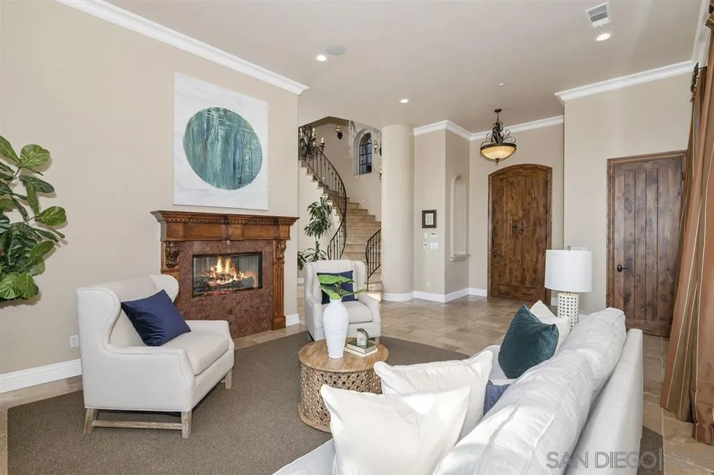 9443 Sunset Avenue La Mesa, CA 91941 - Photo 5 of 25 a living room with furniture a mirror and a fireplace