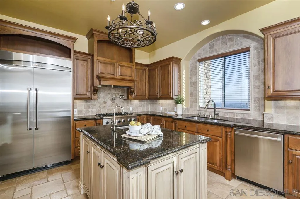 9443 Sunset Avenue La Mesa, CA 91941 - Photo 8 of 25 a kitchen with stainless steel appliances granite countertop a sink a counter space and refrigerator
