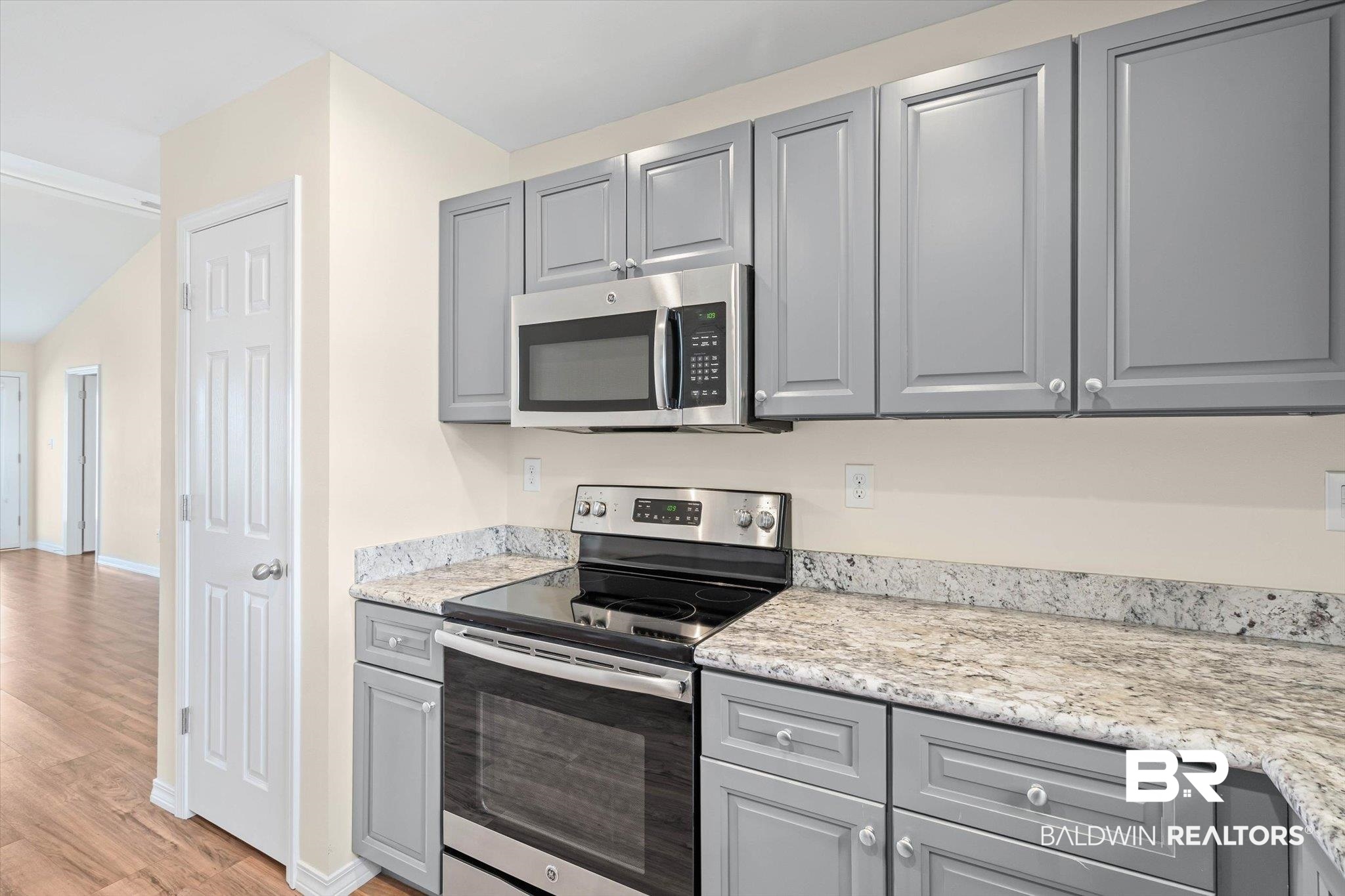919 Sailor Circle Foley, AL 36535 - Photo 8 of 24 Kitchen featuring gray cabinets, stainless steel appliances, light wood-style floors, and light stone countertops