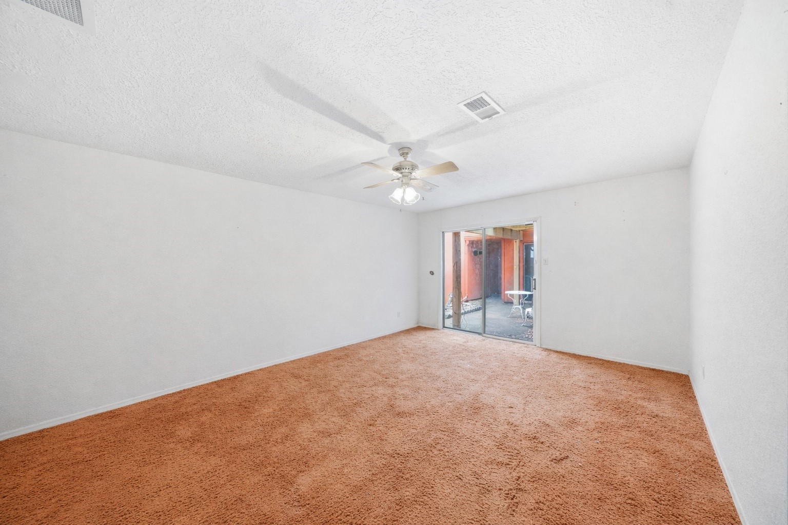 5822 Skewen Street Humble, TX 77346 - Photo 18 of 29 Primary bedroom with sliding doors to the outdoor patio.