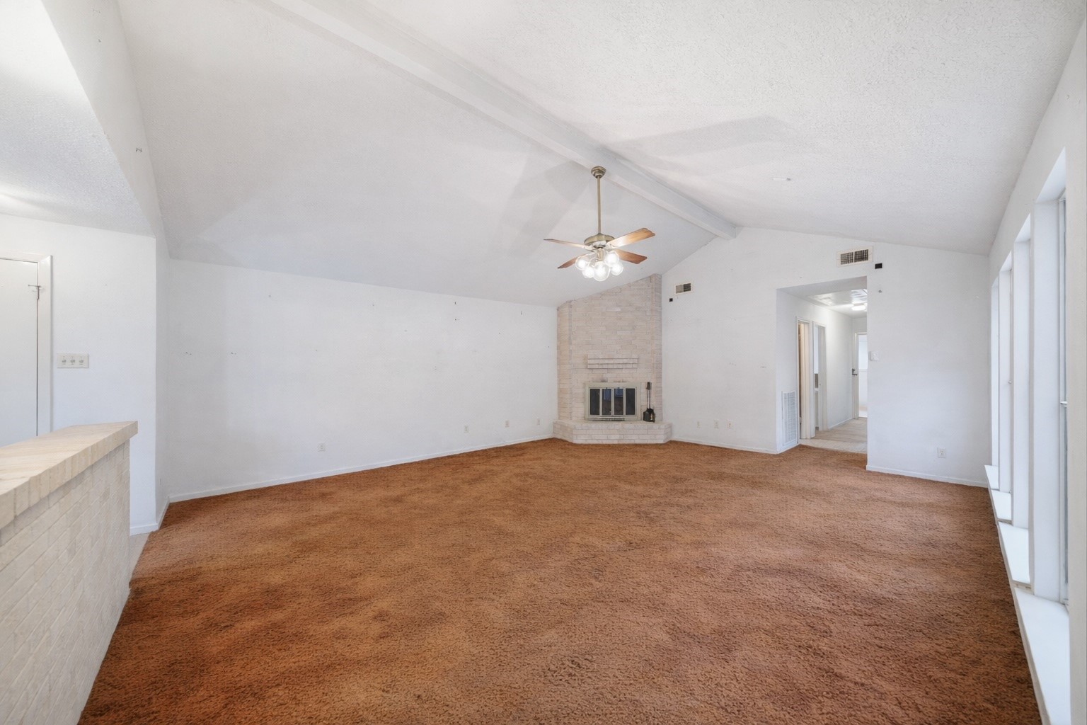 5822 Skewen Street Humble, TX 77346 - Photo 8 of 29 The living room opens to the dining room, just on the other side of the half-brick wall.