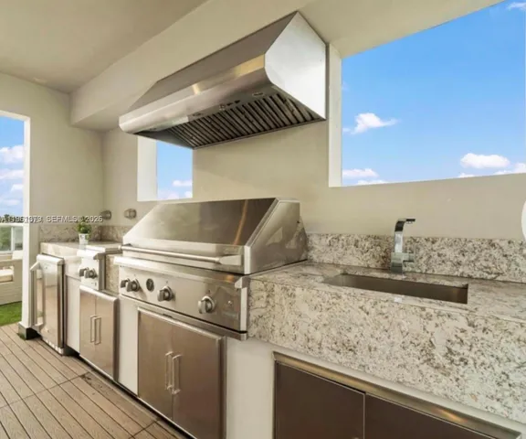 a kitchen with a stove and a sink
