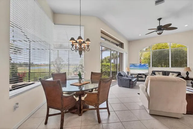 a view of a dining room with furniture large windows and wooden floor