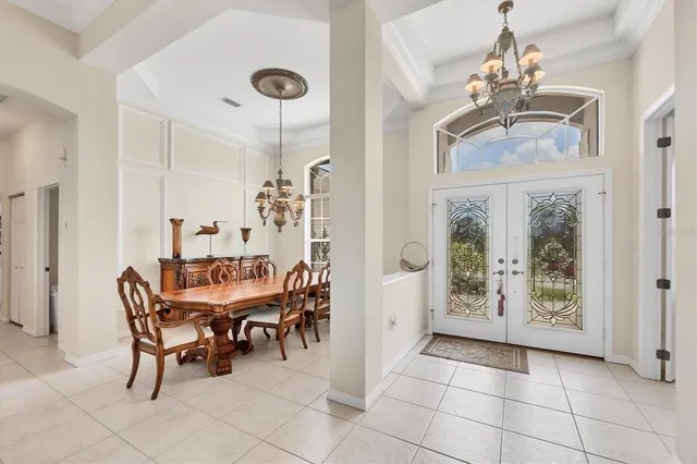 a view of a dining room with furniture and chandelier