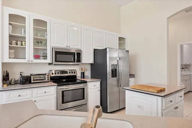 a kitchen with cabinets stainless steel appliances and a counter space