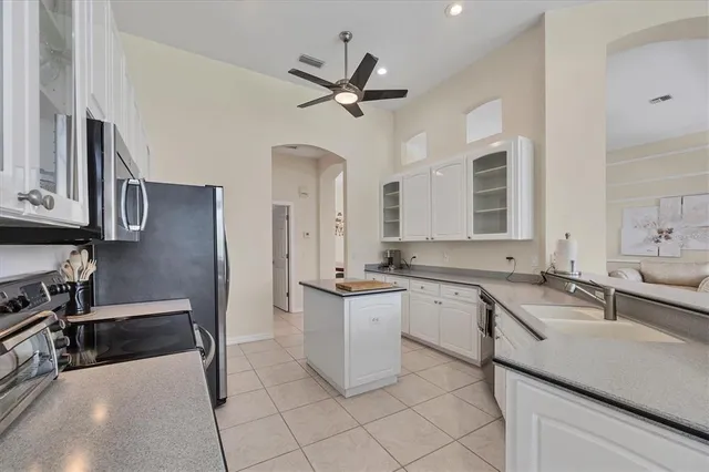 a kitchen with a sink stainless steel appliances and cabinets