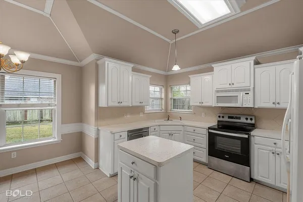 a kitchen with white cabinets and white appliances