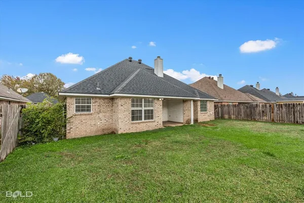 a view of a house with a yard and pathway