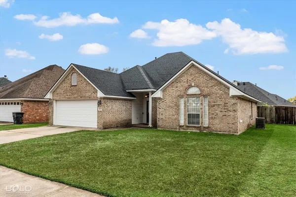 a front view of house with yard and garage