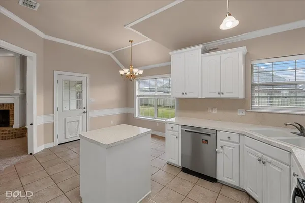a kitchen with white cabinets and a stove top oven