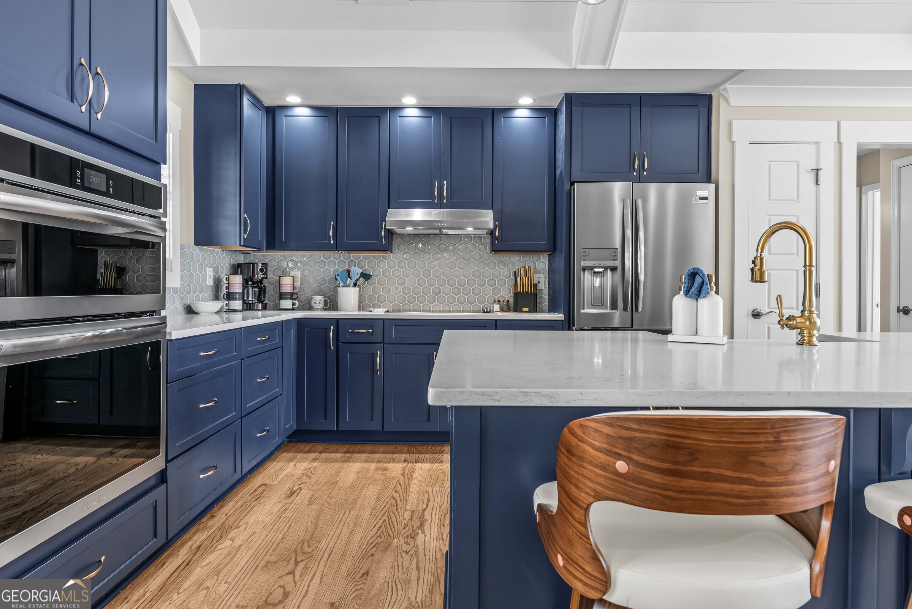 766 South Steel Bridge Road Eatonton, GA 31024 - Photo 21 of 71 a kitchen with wooden cabinets and stainless steel appliances