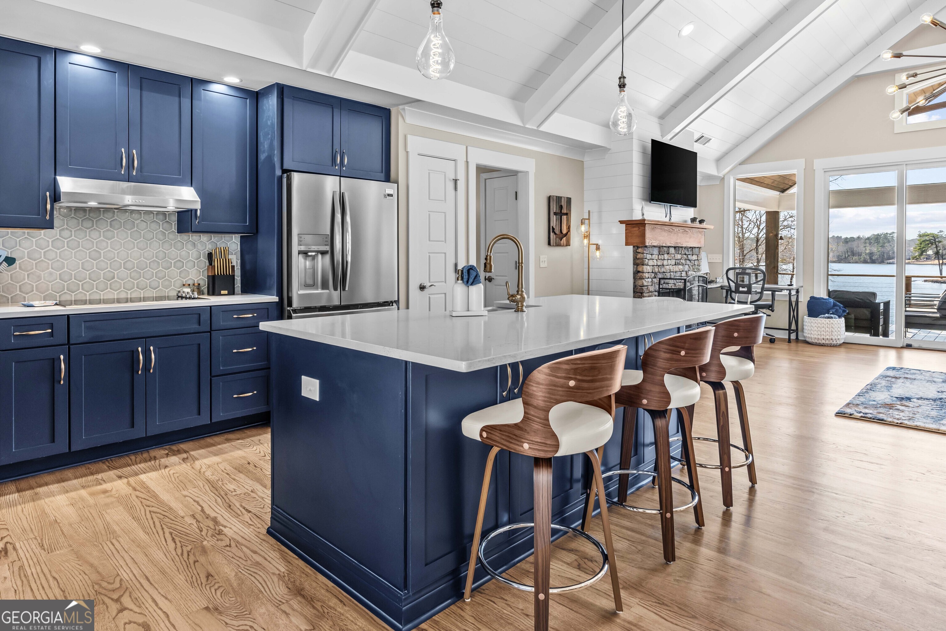 766 South Steel Bridge Road Eatonton, GA 31024 - Photo 22 of 71 a kitchen with stainless steel appliances granite countertop a table chairs sink refrigerator and cabinets