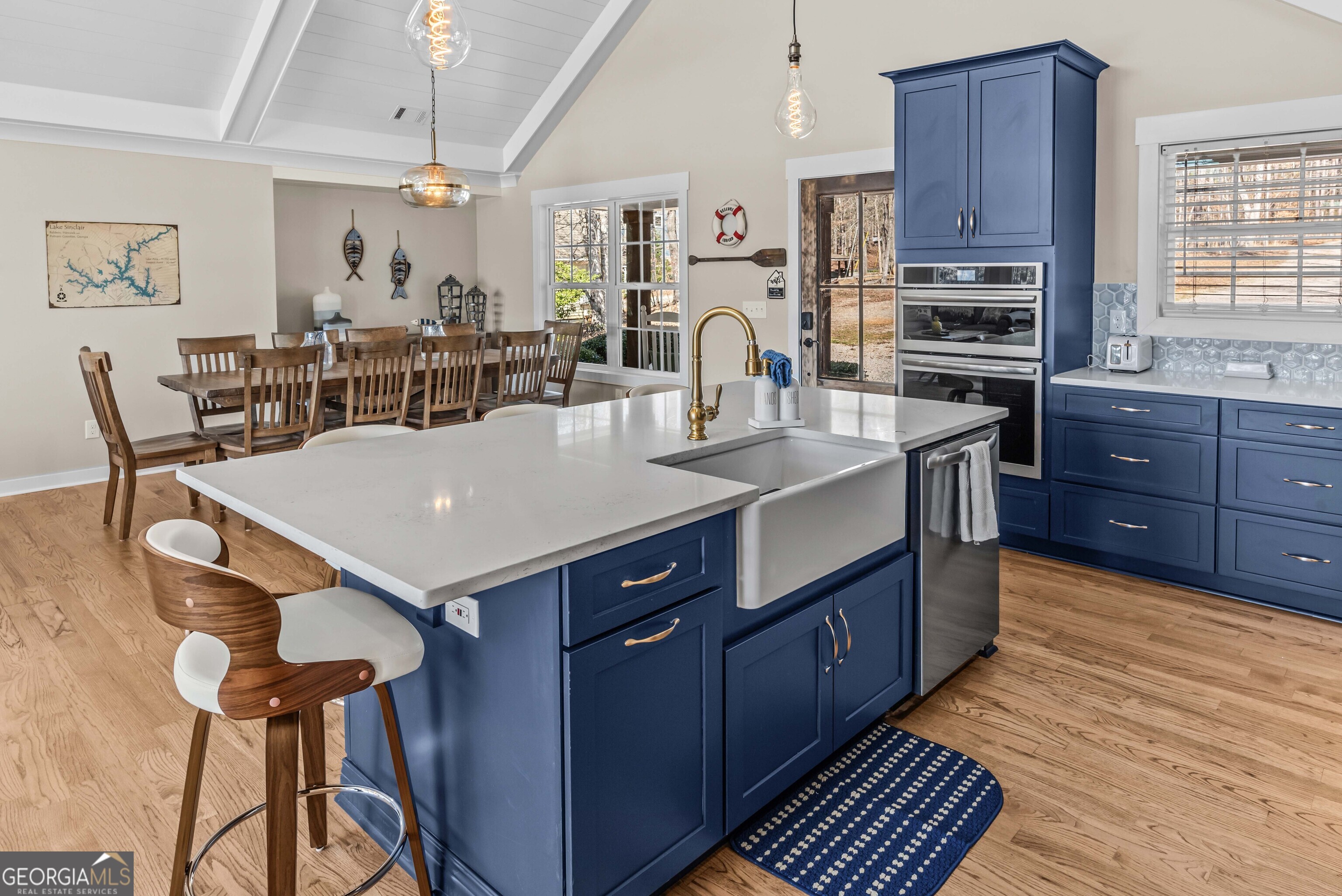 766 South Steel Bridge Road Eatonton, GA 31024 - Photo 25 of 71 a large kitchen with kitchen island a stove a sink a dining table and chairs