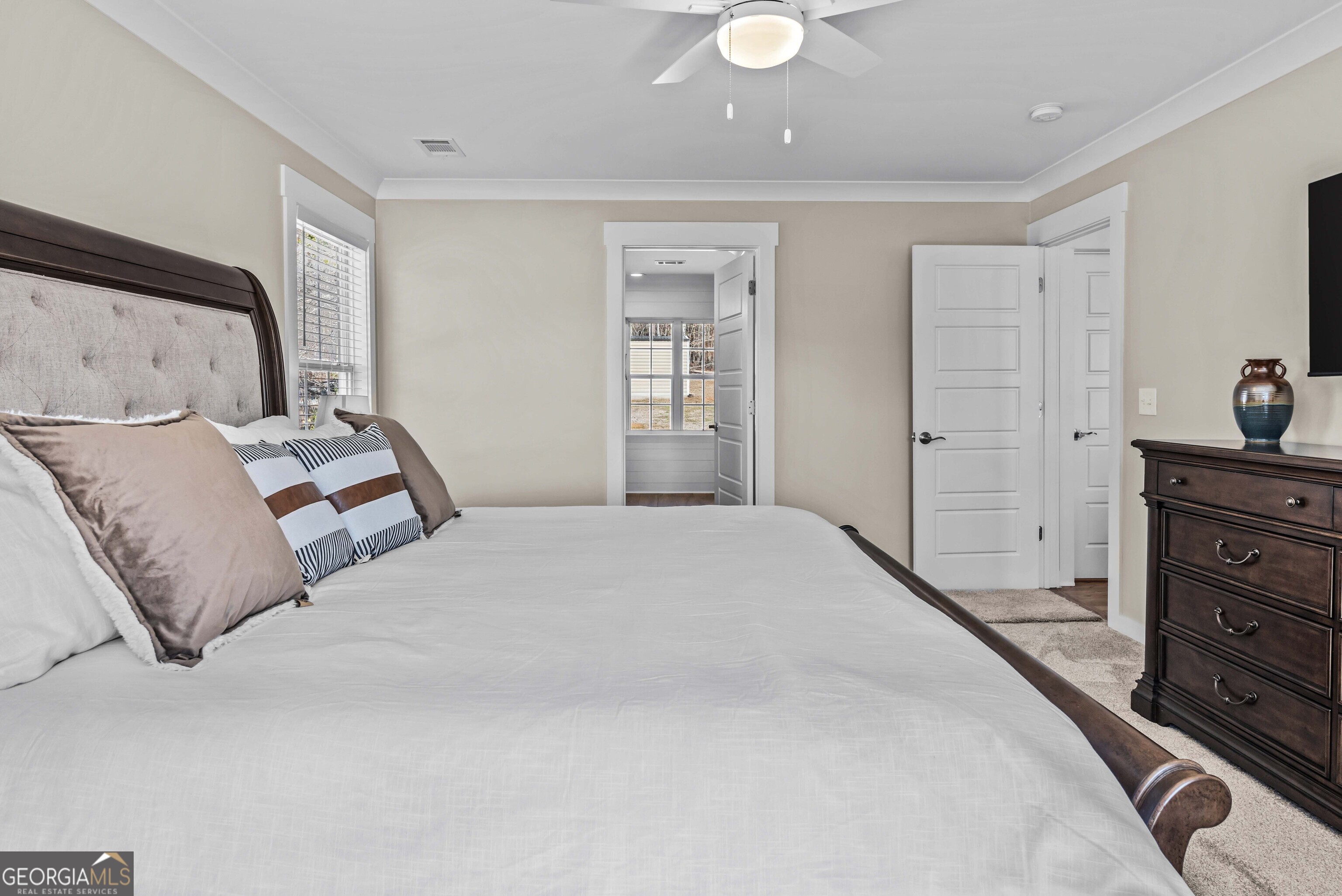 766 South Steel Bridge Road Eatonton, GA 31024 - Photo 28 of 71 a bedroom with a bed and cabinet