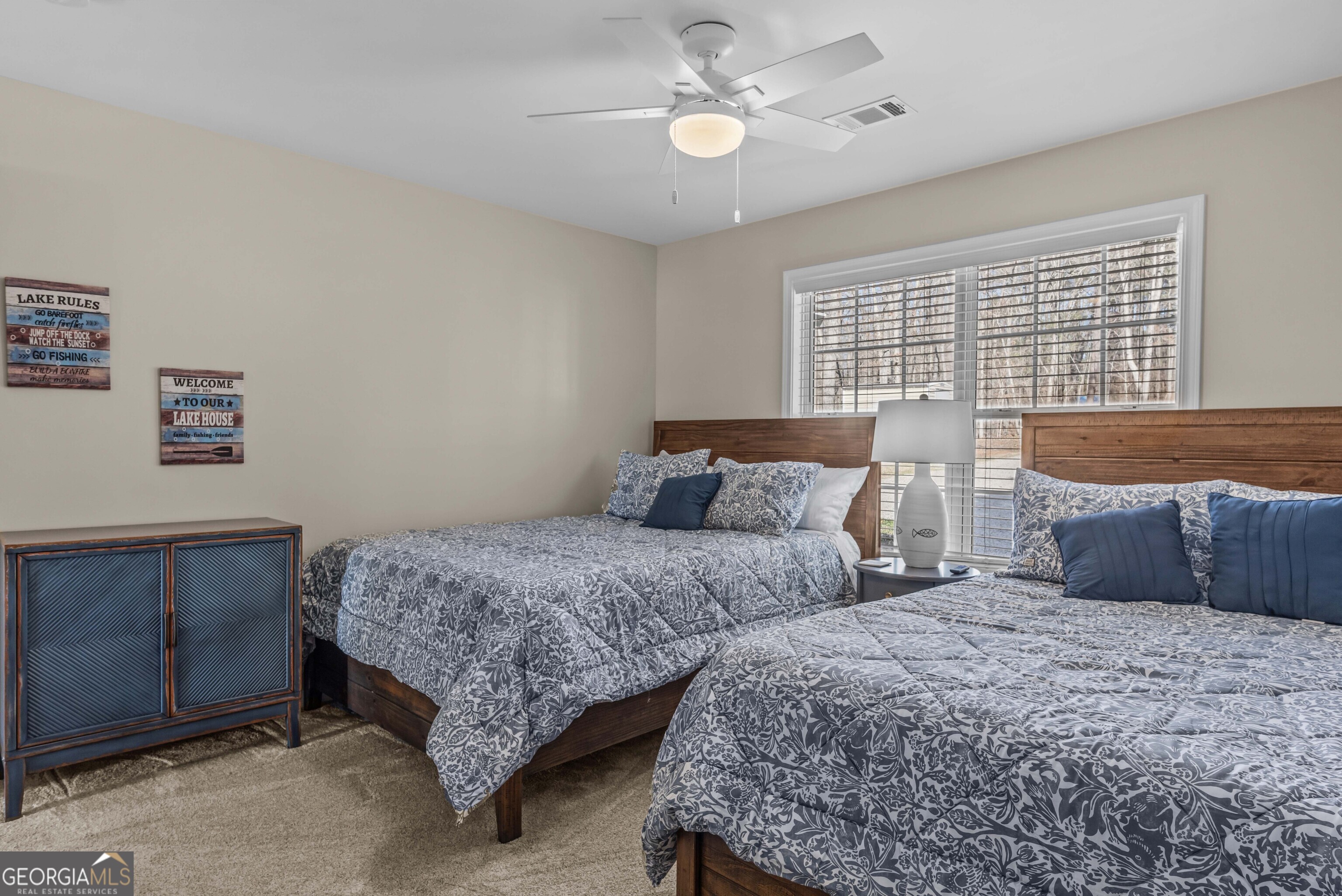 766 South Steel Bridge Road Eatonton, GA 31024 - Photo 36 of 71 a bedroom with two beds and a chandelier