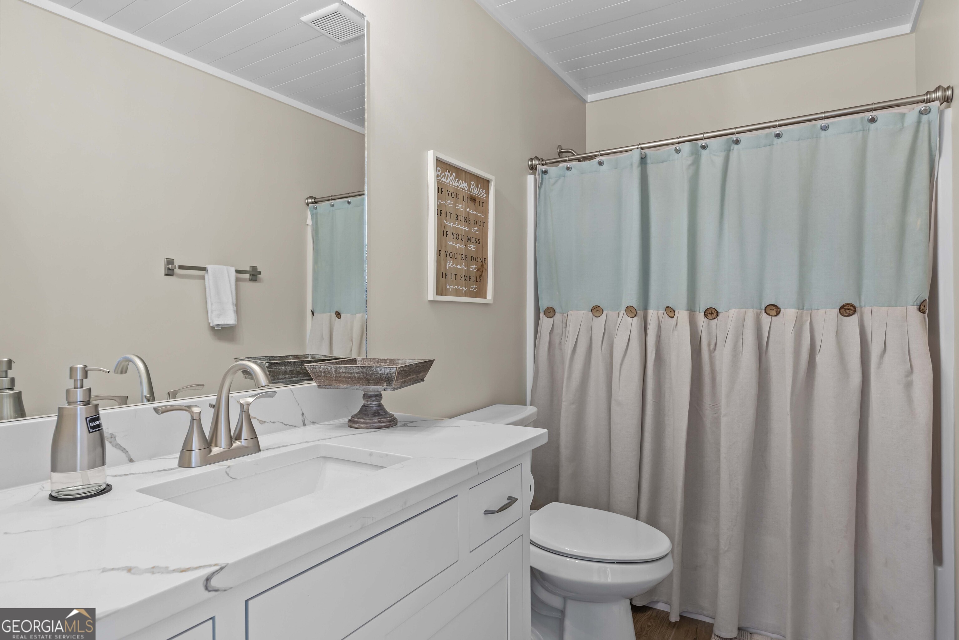 766 South Steel Bridge Road Eatonton, GA 31024 - Photo 37 of 71 a bathroom with a sink a toilet and a mirror