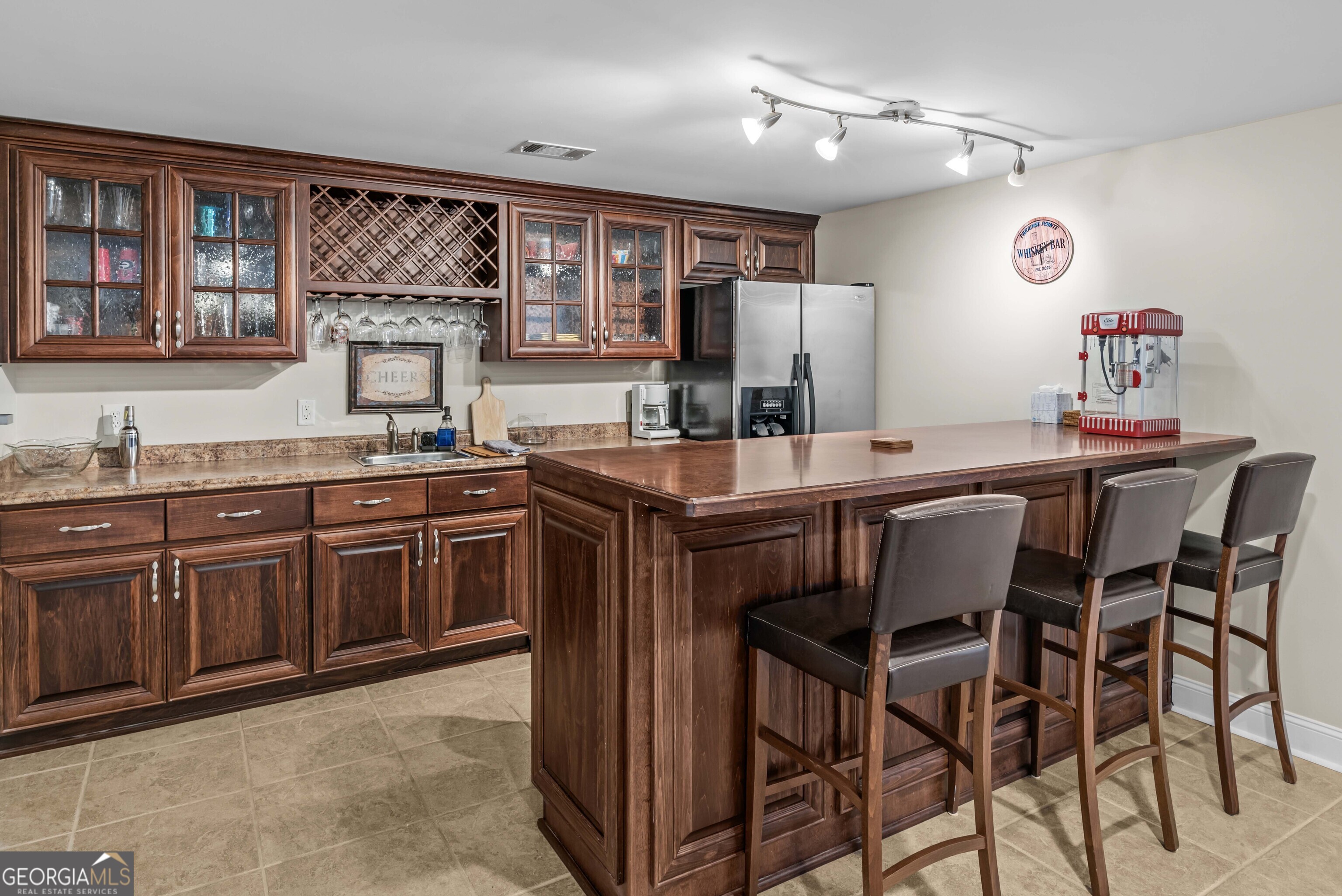766 South Steel Bridge Road Eatonton, GA 31024 - Photo 44 of 71 a kitchen with granite countertop a sink and wooden cabinets