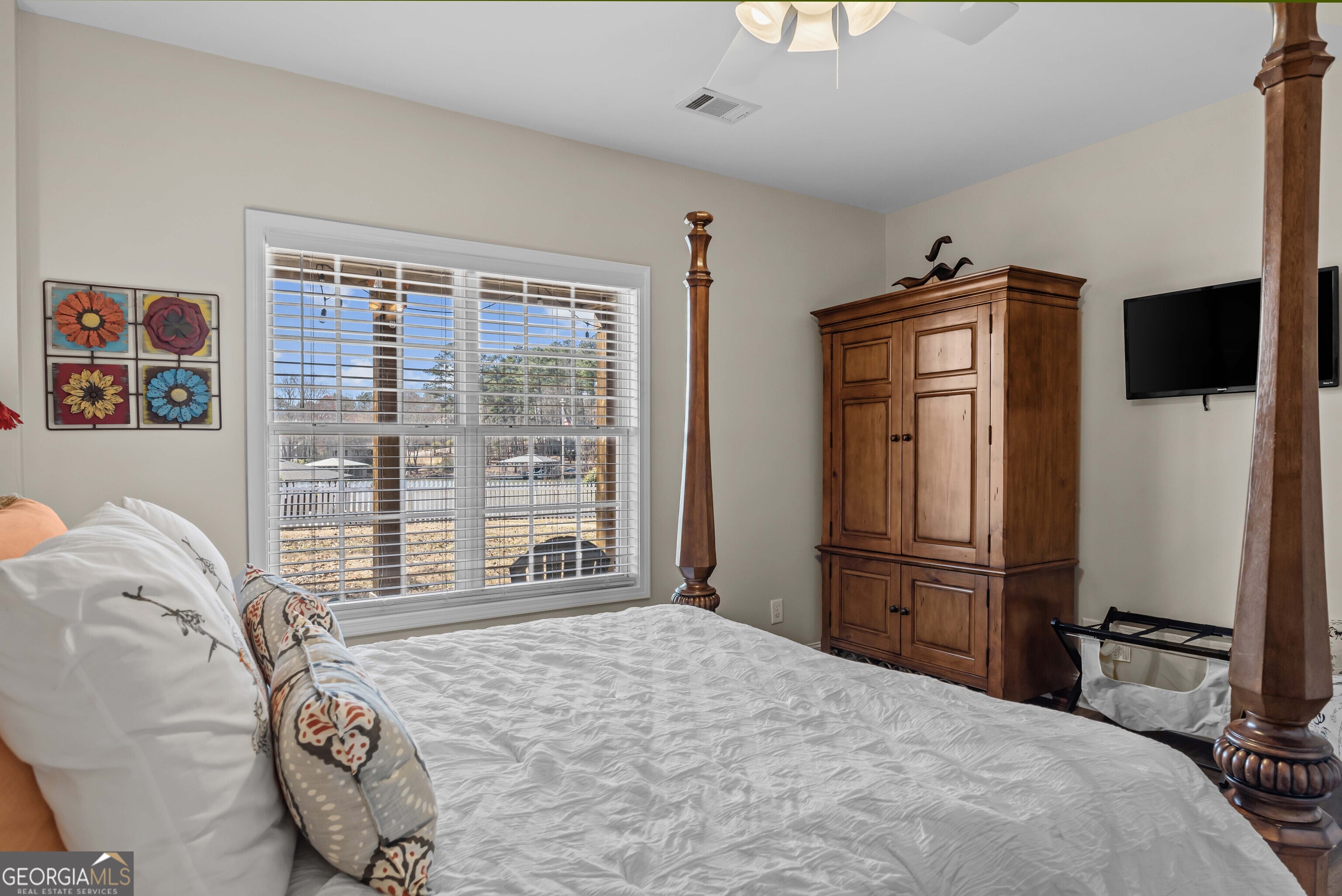 766 South Steel Bridge Road Eatonton, GA 31024 - Photo 48 of 71 a bedroom with a bed and a television