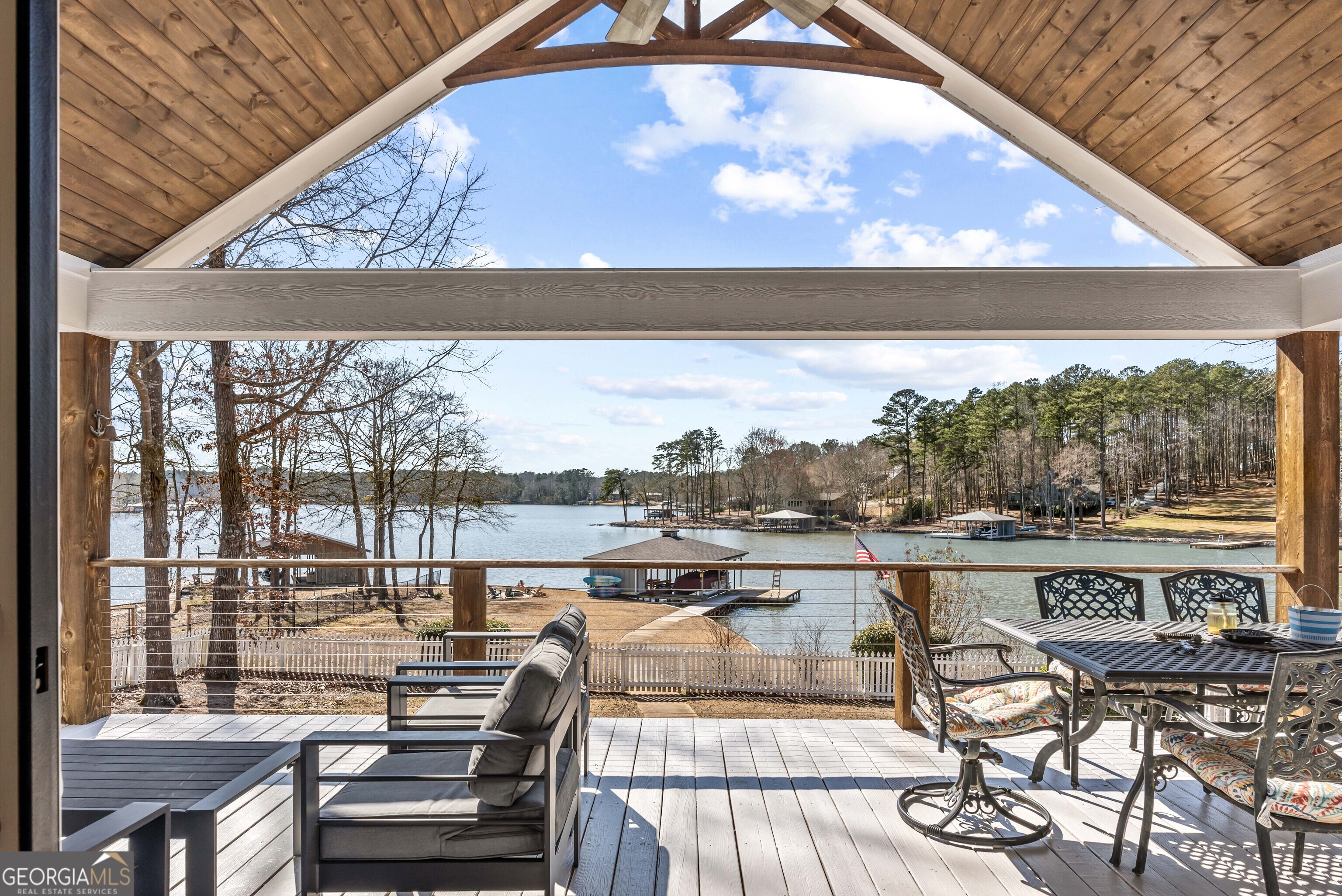 766 South Steel Bridge Road Eatonton, GA 31024 - Photo 54 of 71 a view of a balcony with lake view and wooden floor