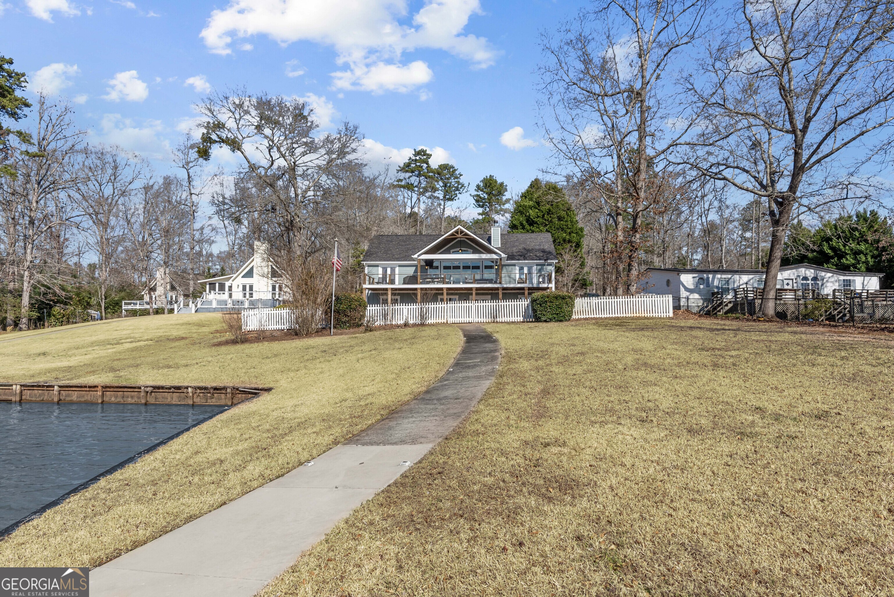 766 South Steel Bridge Road Eatonton, GA 31024 - Photo 59 of 71 a view of swimming pool with outdoor seating and trees in the background