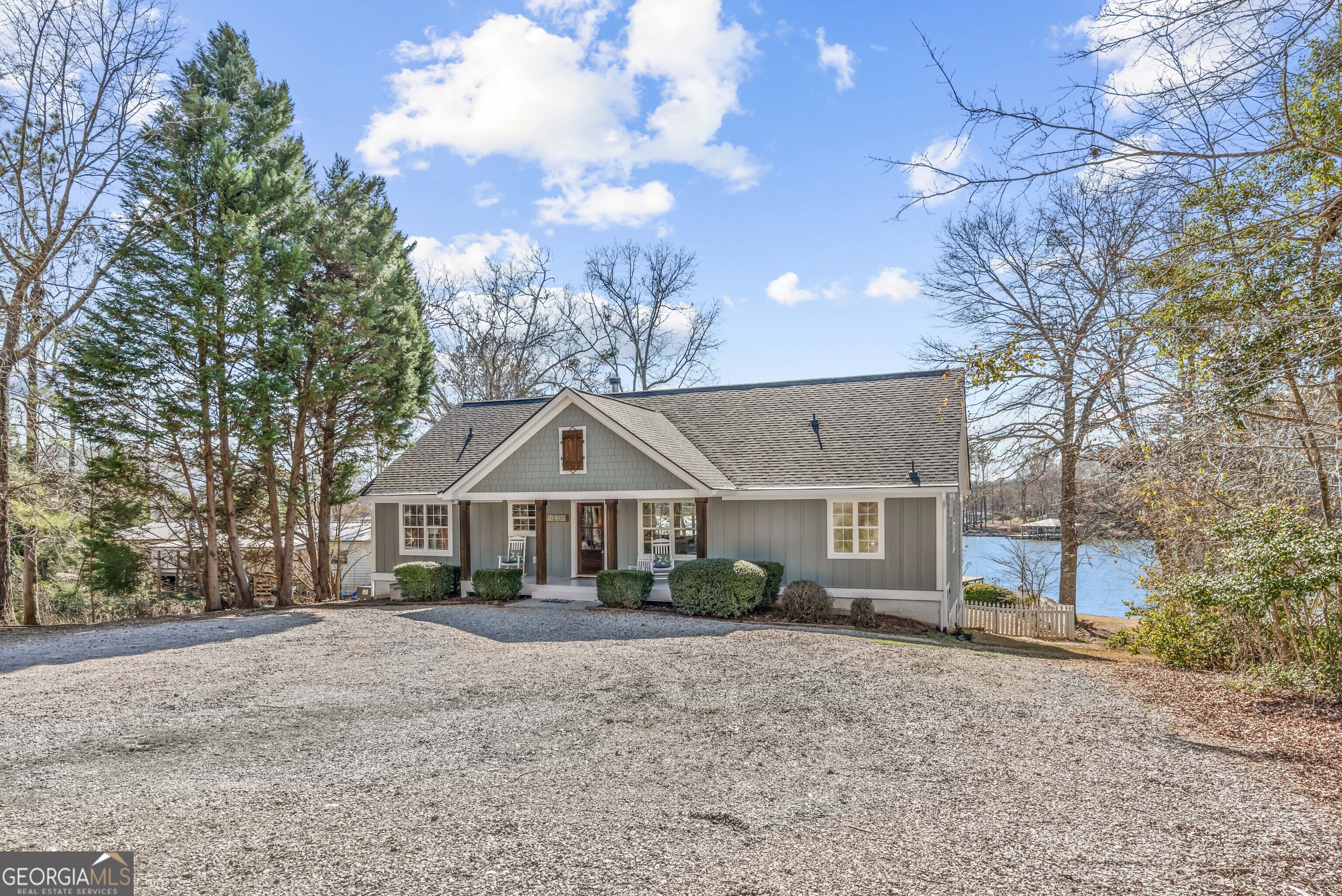 766 South Steel Bridge Road Eatonton, GA 31024 - Photo 6 of 71 a front view of a house with a yard and garage