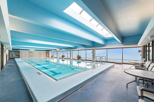 1212 North Lake Shore Drive, Unit 34CN Chicago, IL 60610 - Photo 3 of 6 a view of a patio with table and chairs with wooden floor