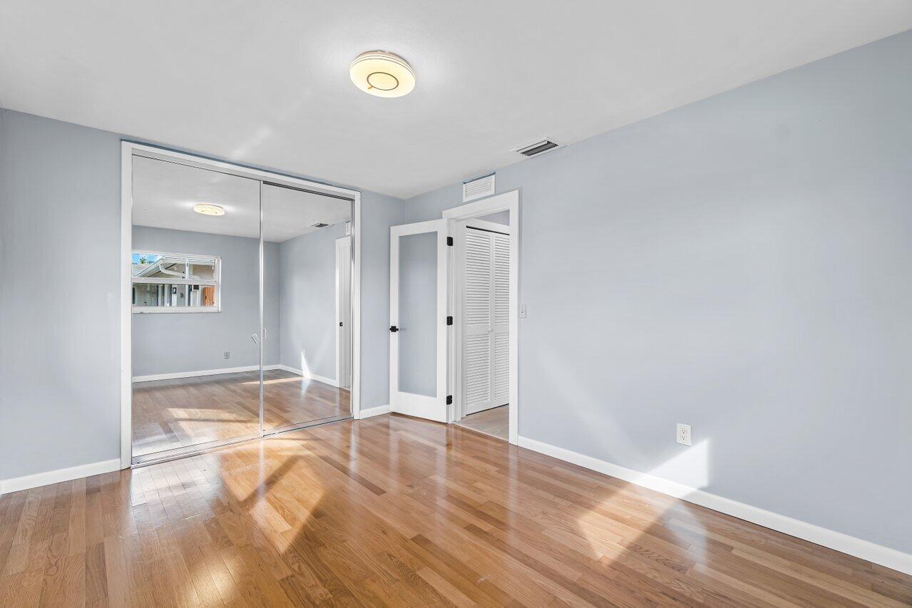1317 Southwest 9th Street Boca Raton, FL 33486 - Photo 24 of 41 a view of an empty room with wooden floor and a window
