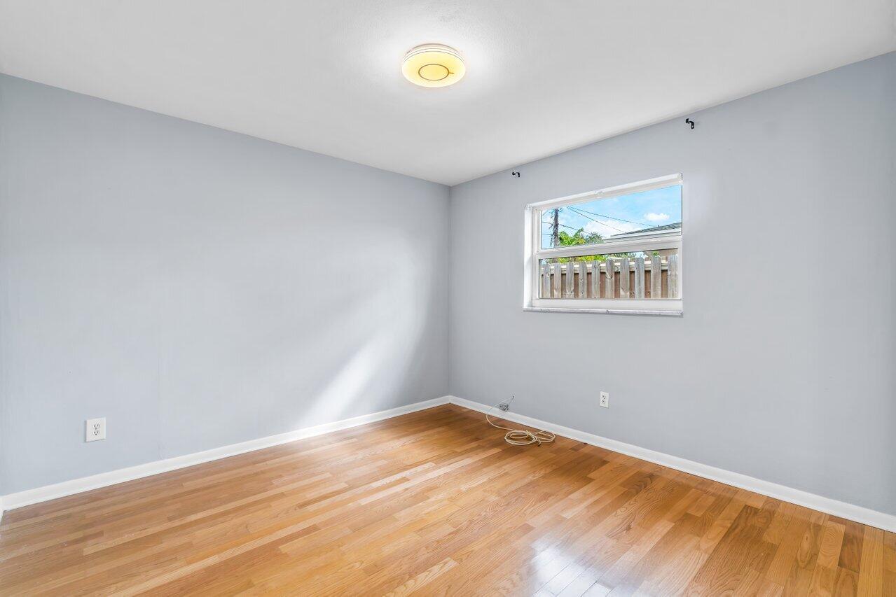 1317 Southwest 9th Street Boca Raton, FL 33486 - Photo 26 of 41 a view of empty room with wooden floor and fan