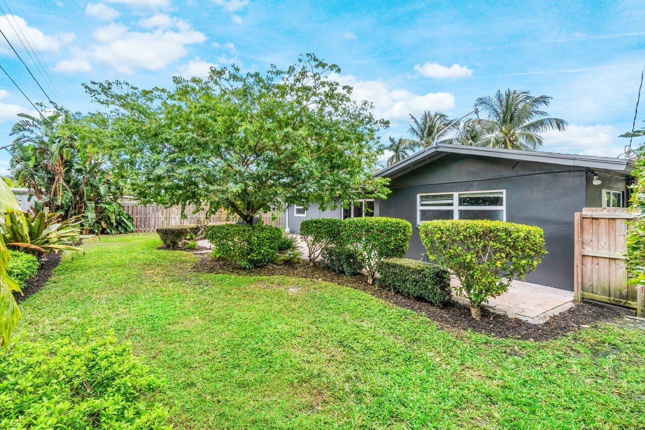 1317 Southwest 9th Street Boca Raton, FL 33486 - Photo 29 of 41 a view of a house with a yard and sitting area