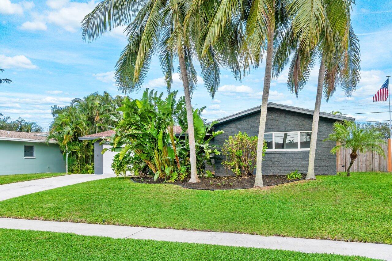 1317 Southwest 9th Street Boca Raton, FL 33486 - Photo 4 of 41 a view of a yard with a palm tree