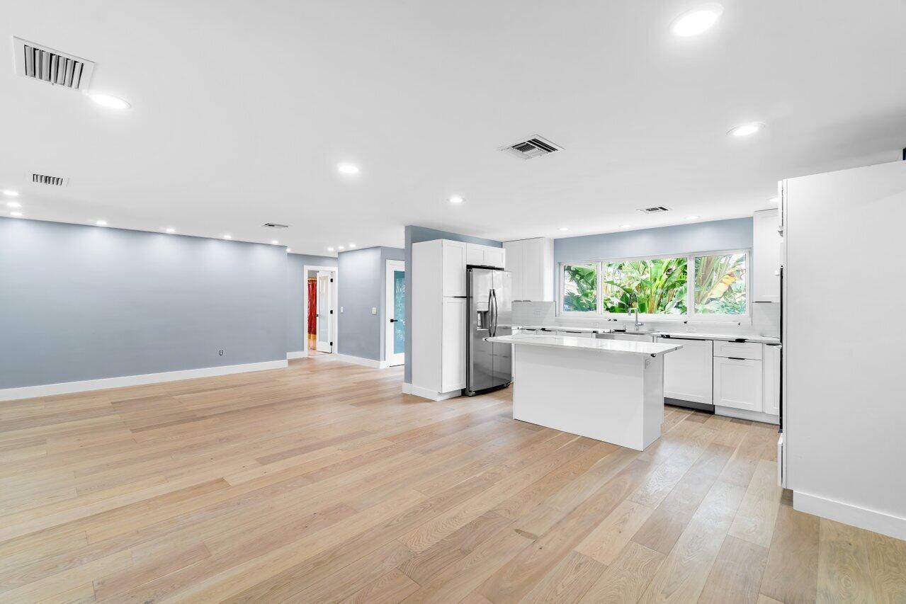 1317 Southwest 9th Street Boca Raton, FL 33486 - Photo 7 of 41 a view of a kitchen with wooden floor and electronic appliances