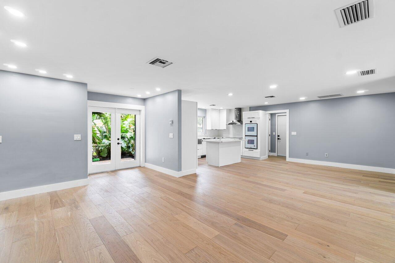 1317 Southwest 9th Street Boca Raton, FL 33486 - Photo 8 of 41 a view of an empty room with a window and wooden floor