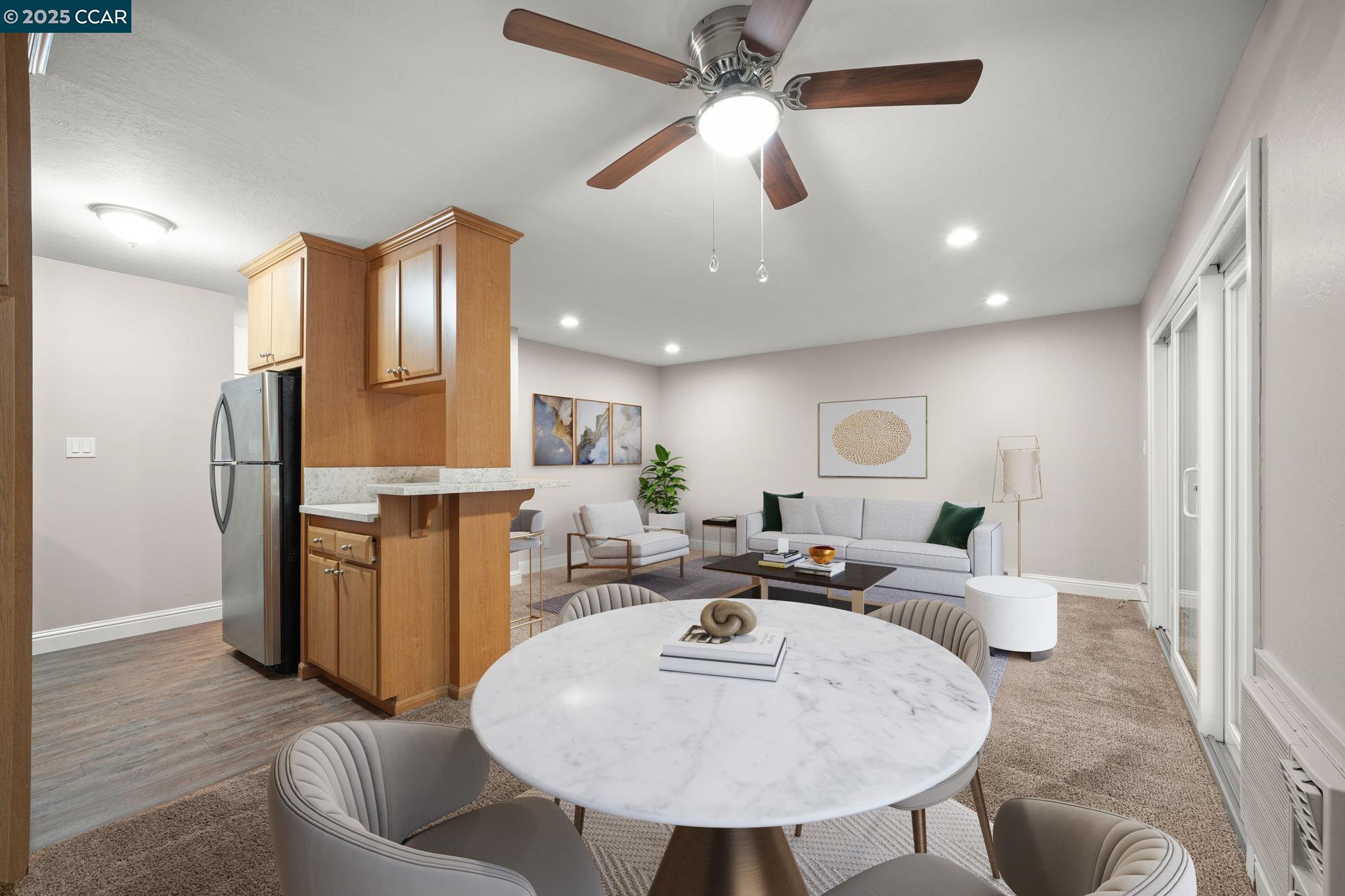 1036 Oak Grove Road, Unit 21 Concord, CA 94518 - Photo 6 of 23 a living room with furniture a refrigerator and kitchen view