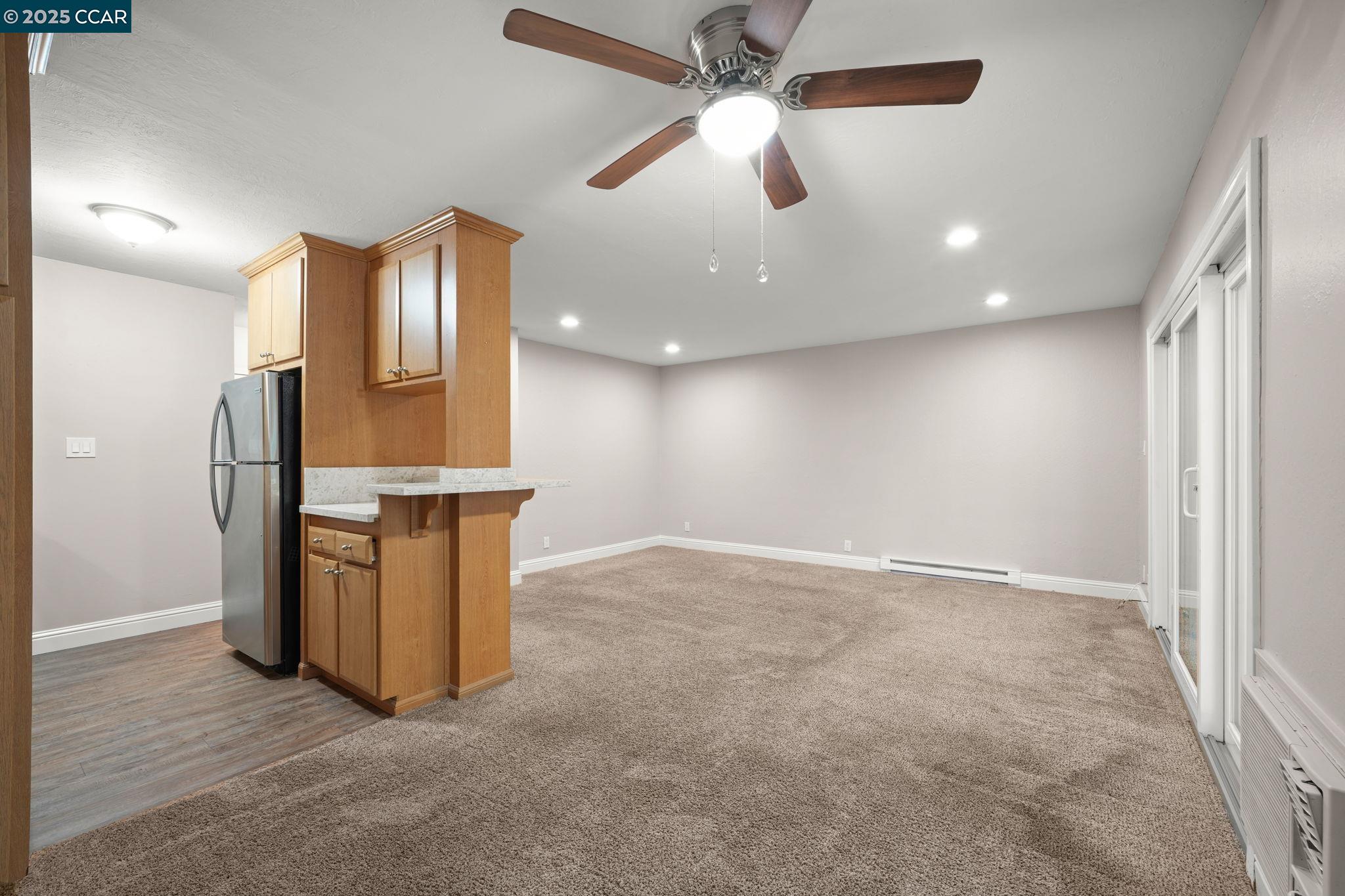 1036 Oak Grove Road, Unit 21 Concord, CA 94518 - Photo 7 of 23 en empty room with windows and ceiling fan