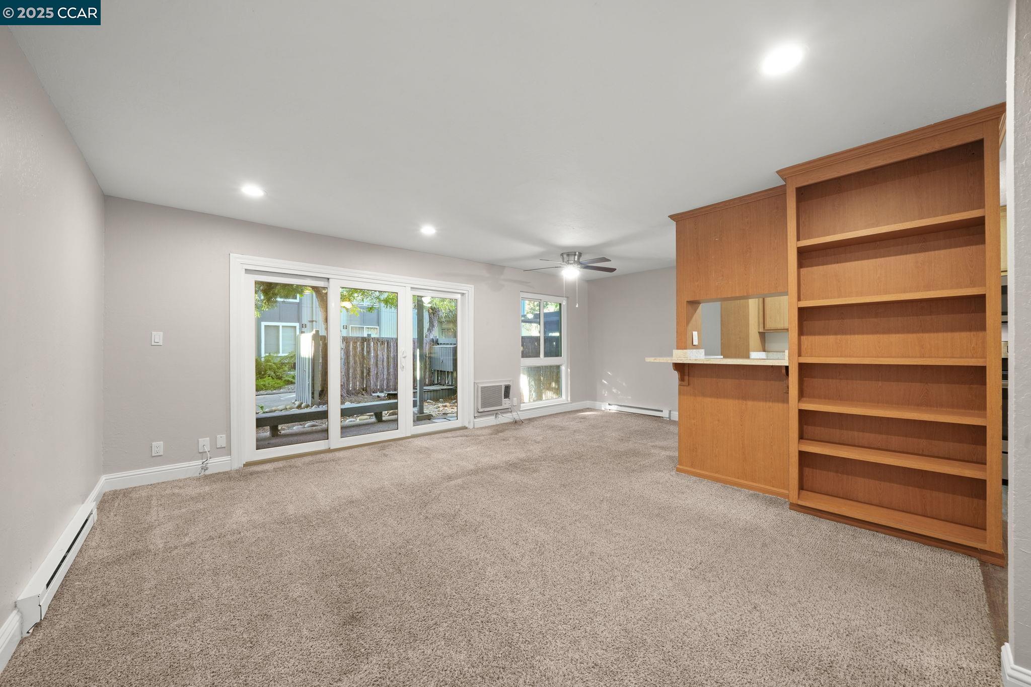 1036 Oak Grove Road, Unit 21 Concord, CA 94518 - Photo 9 of 23 a view of an empty room with a cabinet and a window