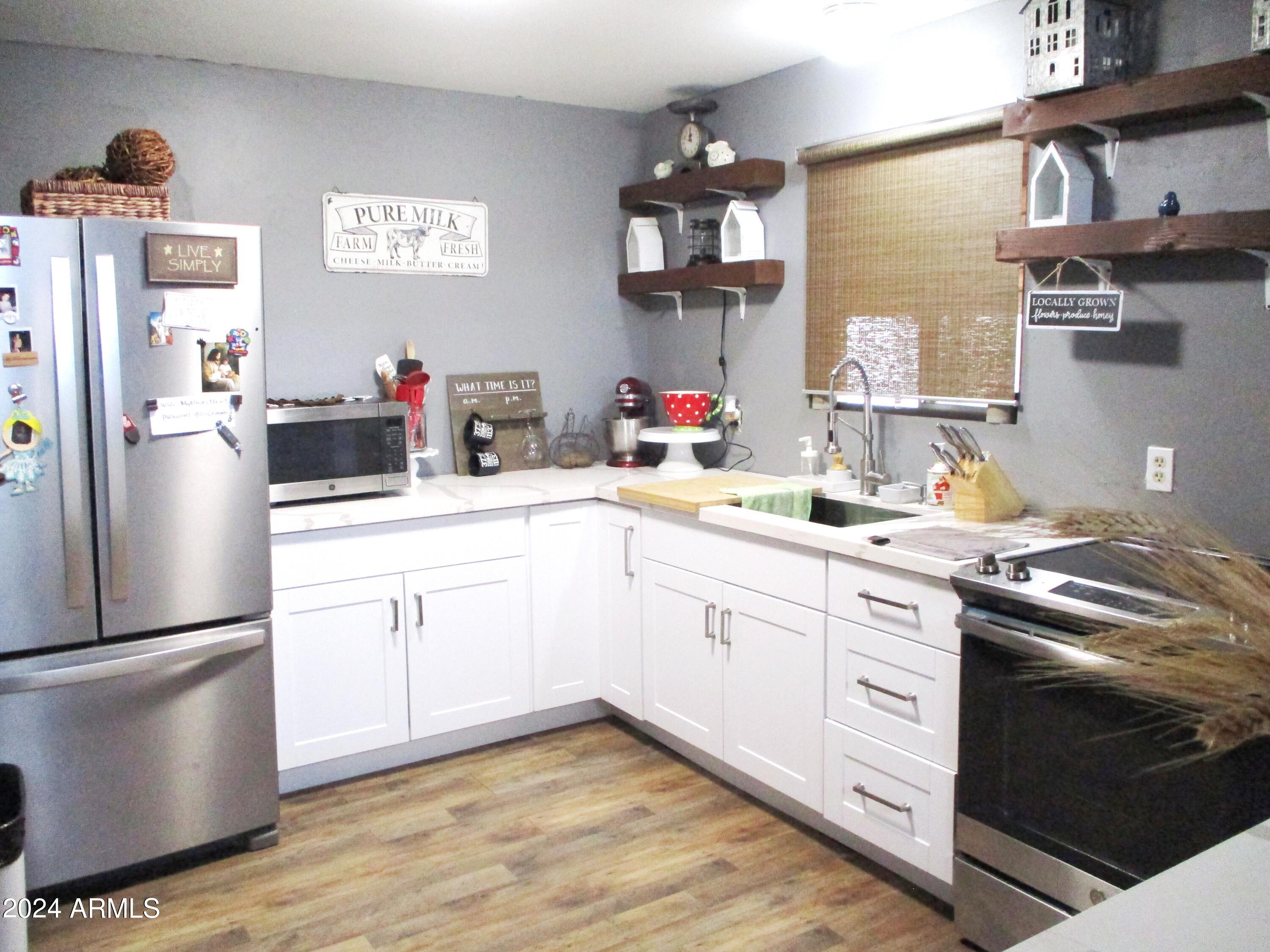 8539 Buffalo Road Strawberry, AZ 85544 - Photo 6 of 19 a kitchen with a sink cabinets and stainless steel appliances