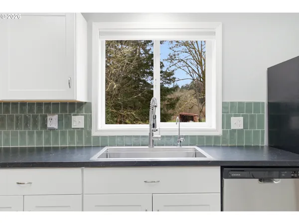 a living room with stainless steel appliances kitchen island granite countertop furniture and a kitchen view