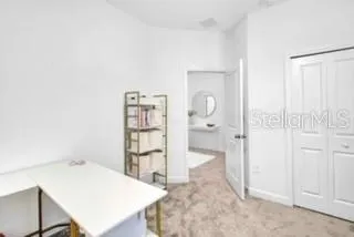 a view of a kitchen with white cabinets and wooden floor