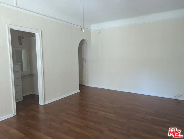 a view of a room with wooden floor