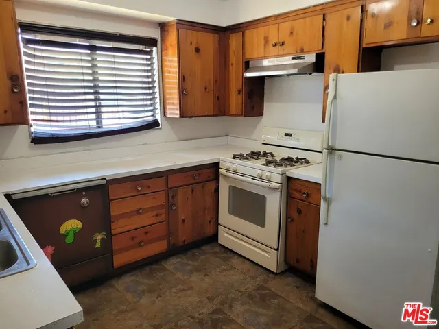 a kitchen with a stove and a refrigerator