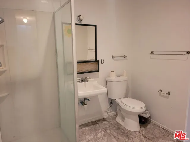 a white toilet sitting next to a bathroom sink