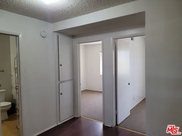 a view of a bathroom with a glass door and a toilet