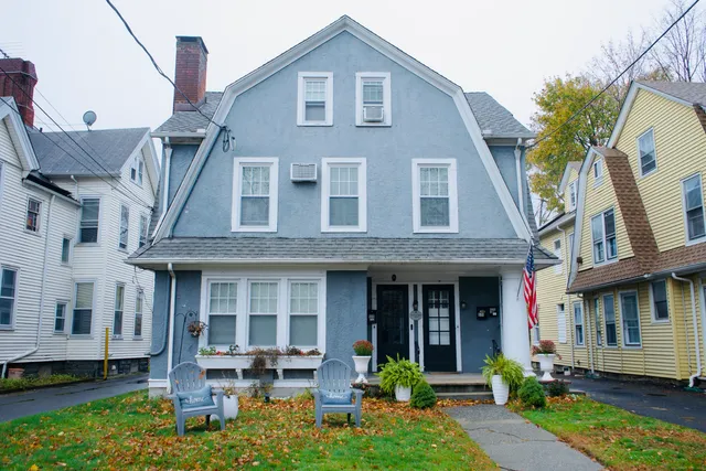 a front view of a house with garden and porch