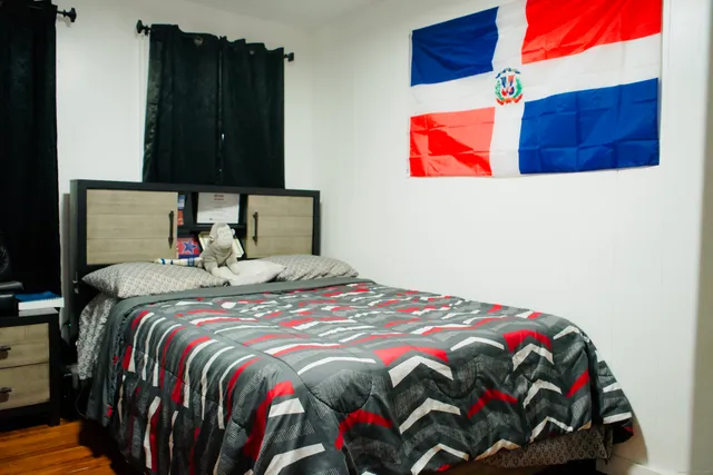 a bedroom with a bed and a painting on the wall