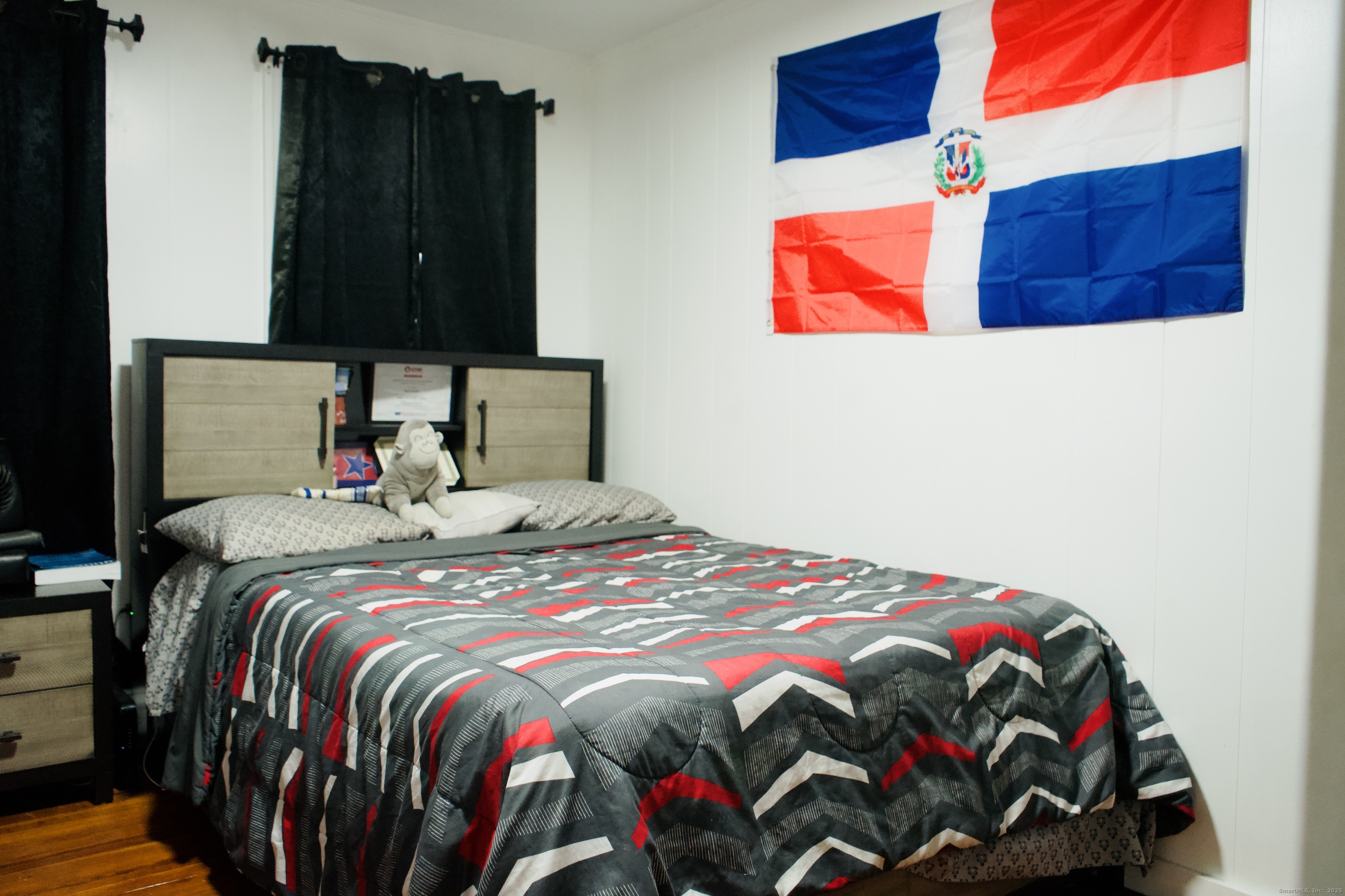 533 Clinton Avenue Bridgeport, CT 06605 - Photo 11 of 18 a bedroom with a bed and a painting on the wall